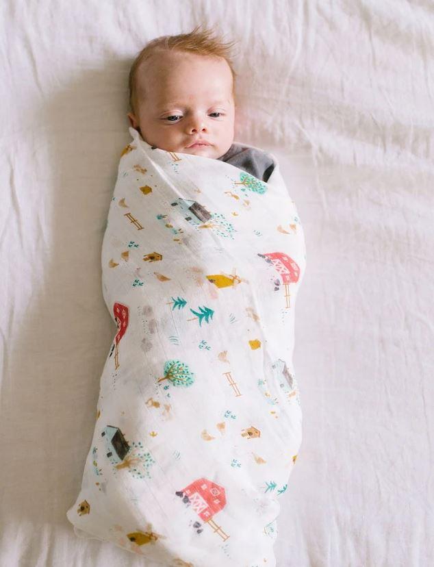 farm animals swaddling blanket features red barns, cows, chicken and all things you need at a farm