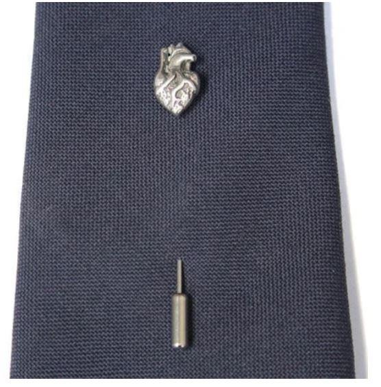 This ascot stickpin is exactly that. A metal 'stick' with an anatomical human heart adornment at the top and a 'clutch' at the bottom (to keep you from poking yourself and to keep your pin secure). It's one of the oldest styles of pins there is, often als