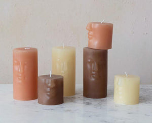 This funky candle has a face! Unscented pillar candle makes it a suitable gift no matter the person. A warm brown colour, this candle will add an element of whimsy to any home.