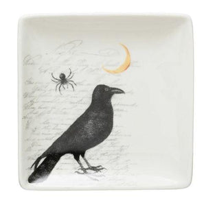 raven bird sitting in from of a waxing moon and a spider, square stoneware side plate