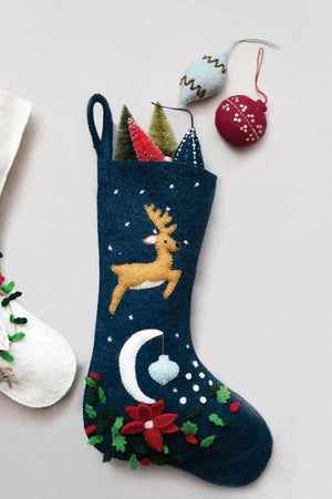 handmade wool felt christmas stocking featuring a reindeer flying over a moon