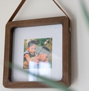 The hanging Picture frame fits a 4x4 inch photo and will add some interest to any home decor. The picture frame is hung from a leather strap and has a wooden frame.