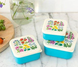 Wildflowers Snack Boxes - Set of 3 perfect for hiking, snacks, lunches. These wildflower snack boxes feature a lovely snap top with a variety of flowers and the base is a light blue. Perfect for spring and summer picnics.