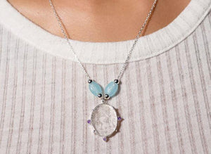 Meda with Amethyst & Silver Necklace Artful, skilled, and knowing. This mystical 3-eyed being is surrounded by amethyst stones which are connected to protection and serenity. The pendant is enhanced by two beads decorated with eyes of protection.